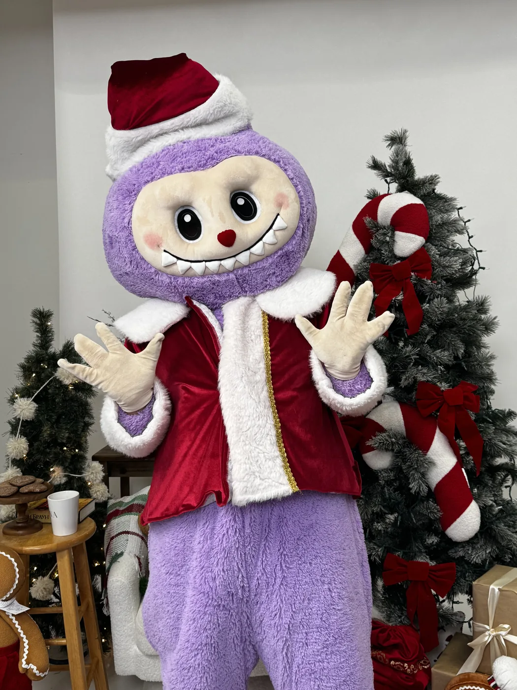 New Year Labubu in a Santa coat by a Christmas tree