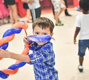 Boy holding twisted balloon figure