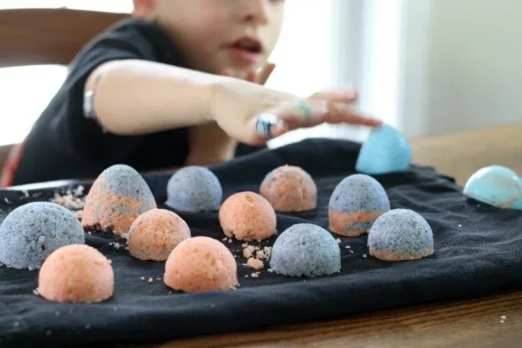 Kid with colorful homemade bath bombs