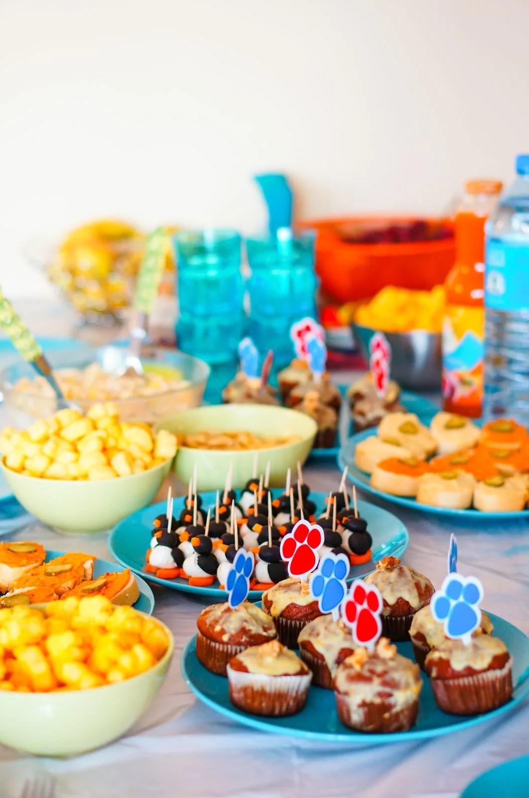 Decorated party table with cupcakes and finger foods