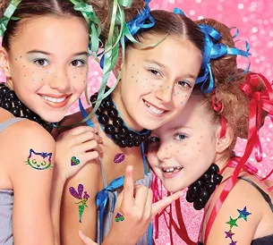 Three girls showing off colorful glitter tattoos