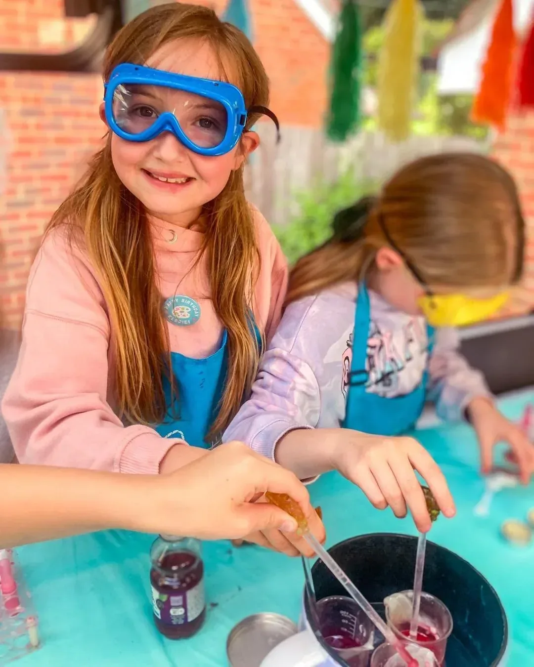 Girl in goggles mixing lip balm ingredients