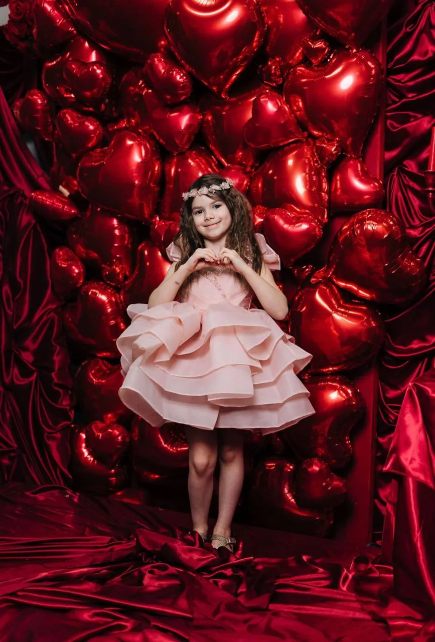 Kids at a Valentine's Day themed craft celebration