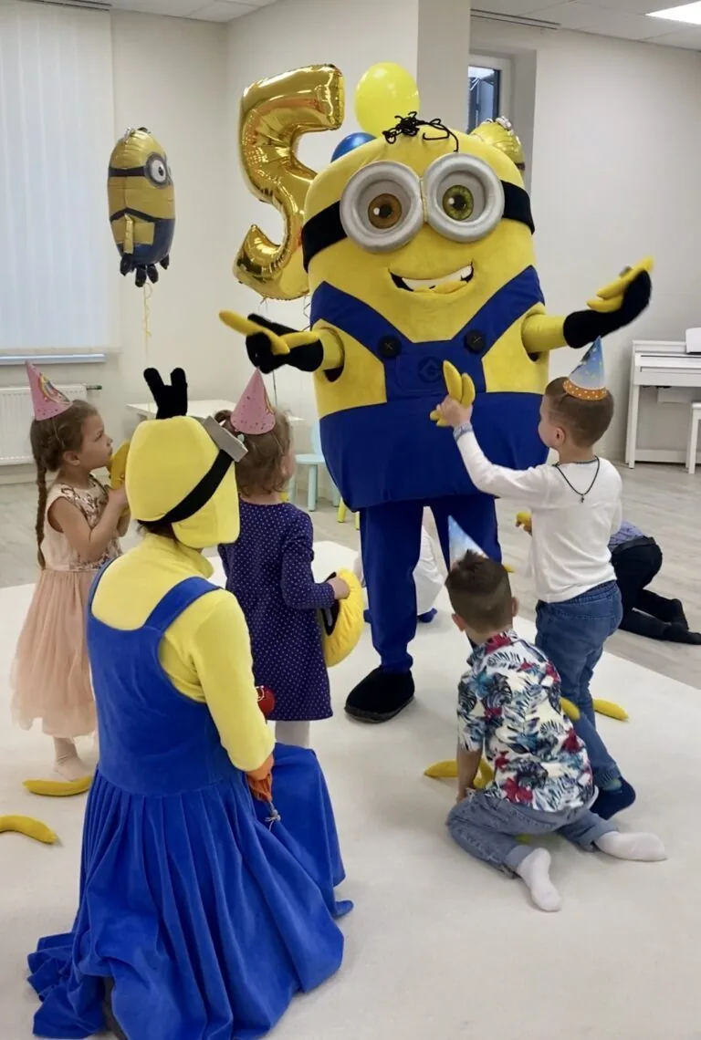 Minion mascot with kids at a birthday party