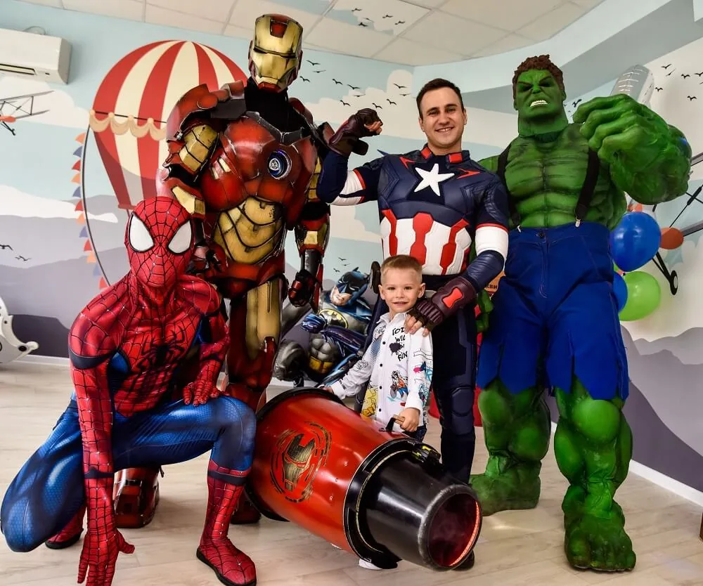 Spider-Man, Iron Man, Captain America and Hulk with a happy boy
